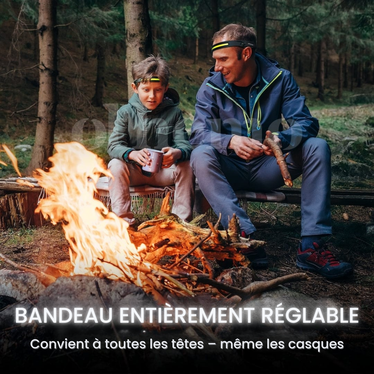 Père et fils autour d'un feu de camp en forêt portant la lampe frontale Lumora à bandeau réglable